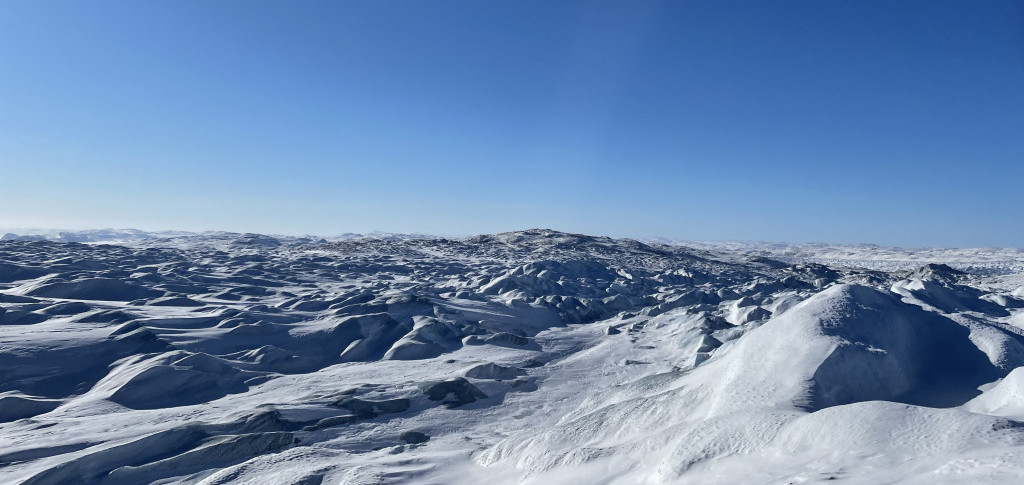 A vast landscape of ice and hills in Greenland.